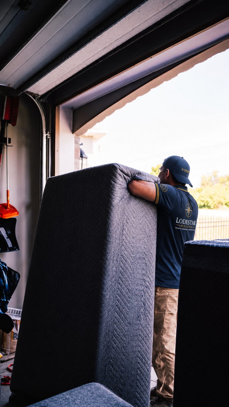 A Lodestar Movers crew member carefully carrying a wrapped mattress