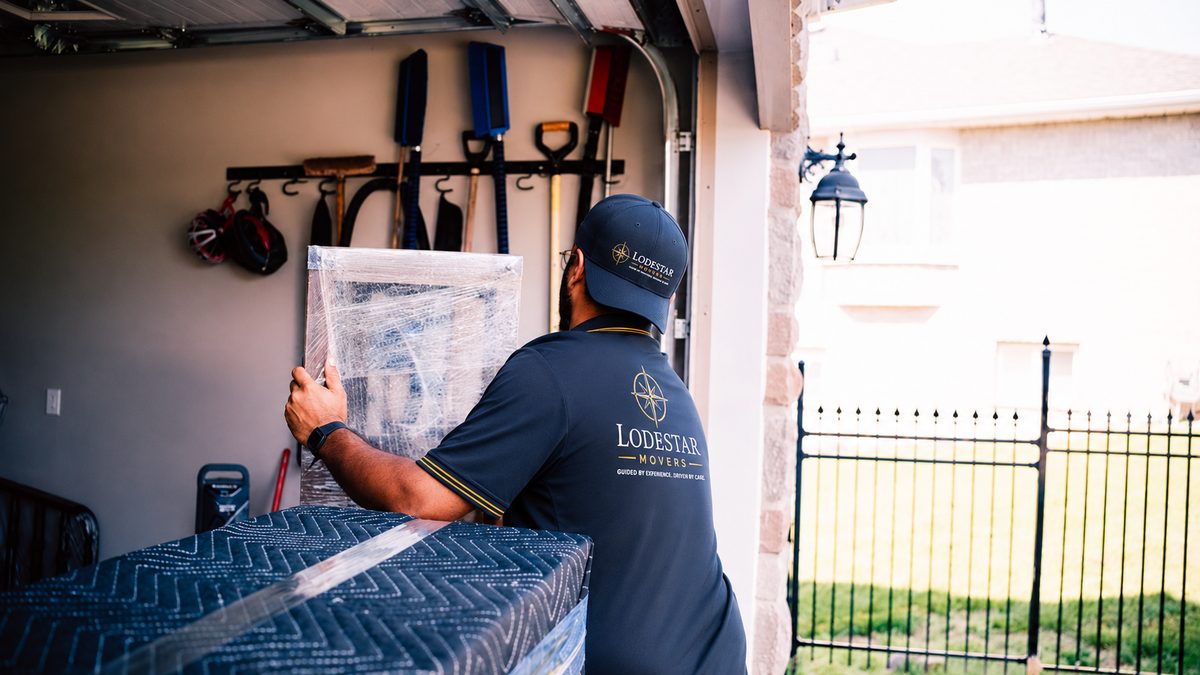 A Lodestar Movers crew member wrapping and protecting furniture